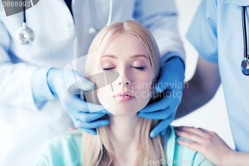 Image of plastic surgeon or doctor with patient