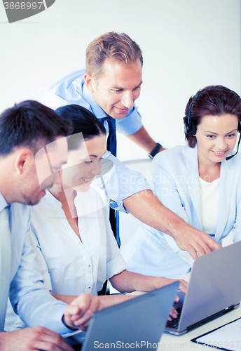 Image of group of people working in call center