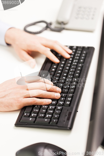 Image of close up of businessman hands typing on keyboard