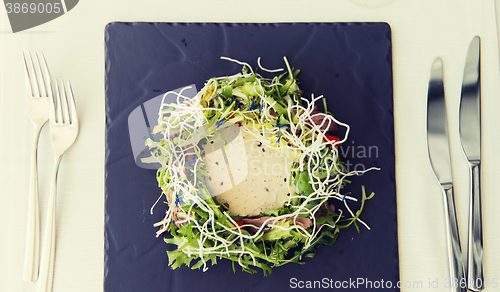 Image of close up of poultry salad with sauce at restaurant