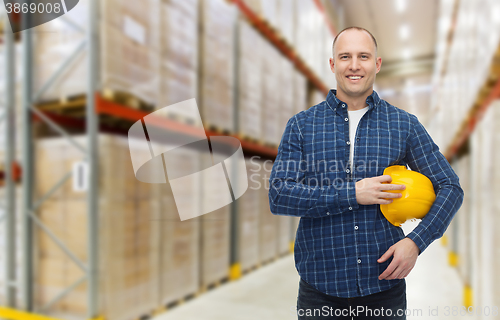 Image of happy man with hardhat over warehouse