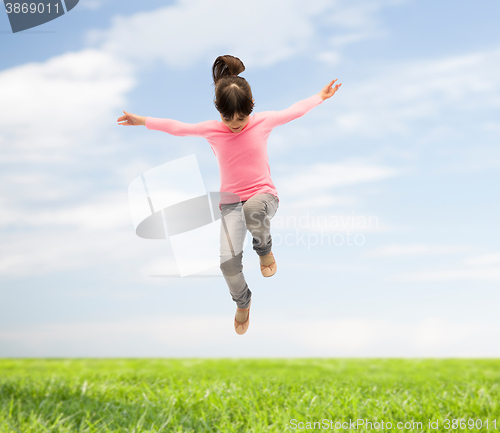Image of happy little girl jumping in air