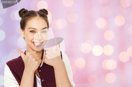 Image of happy pretty teenage girl showing thumbs up