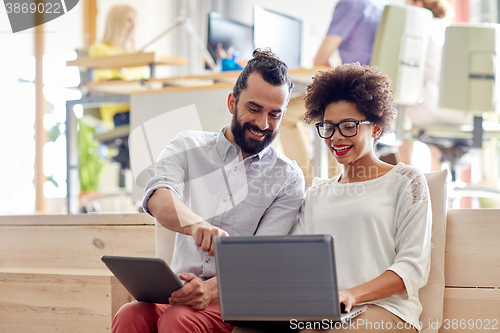 Image of creative team with laptop and tablet pc in office