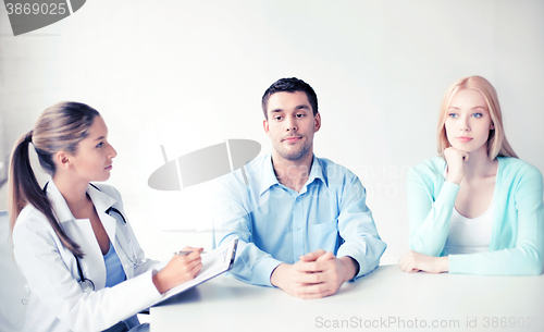 Image of doctor with patients in cabinet