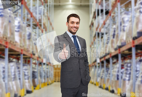 Image of happy man at warehouse showing thumbs up gesture