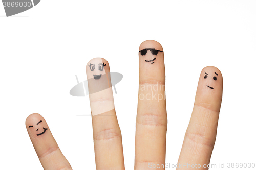 Image of close up of hands and fingers with smiley faces