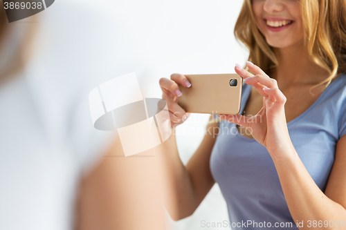Image of close up of teen girl taking picture by smartphone