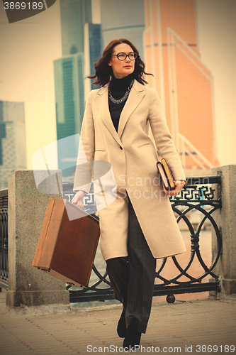 Image of woman with a wooden case and books