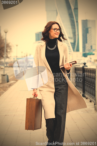 Image of middle-aged woman in a bright coat