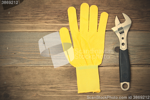 Image of yellow glove and adjustable spanner