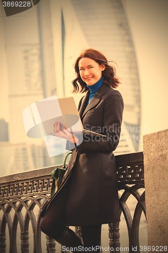 Image of beautiful woman with a laptop