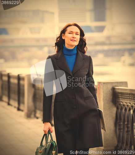 Image of beautiful middle-aged woman in a dark coat