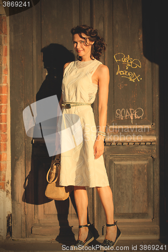 Image of attractive middle-aged woman in a bright dress