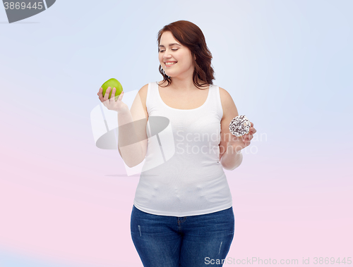 Image of happy plus size woman choosing apple or donut