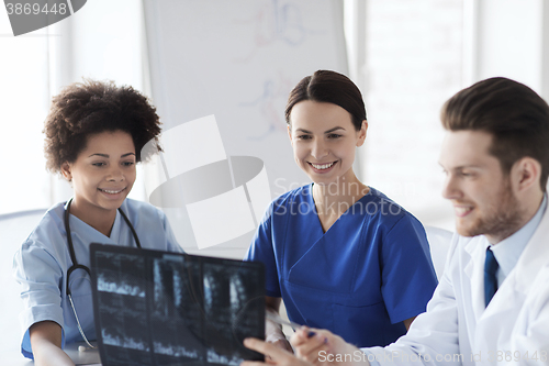 Image of group of happy doctors discussing x-ray image