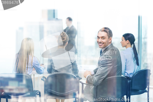 Image of businessman with team in office