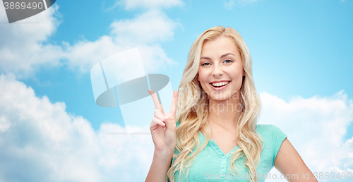 Image of smiling young woman or teenage girl showing peace