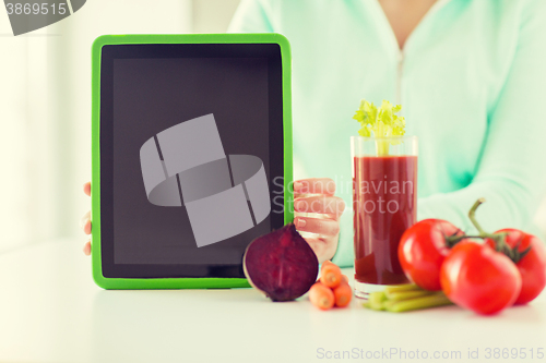 Image of close up of woman with tablet pc and vegetables