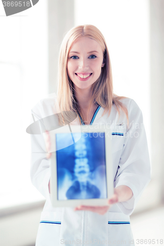 Image of female doctor with x-ray on tablet pc