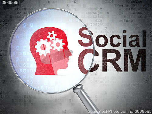 Image of Advertising concept: Head With Gears and Social CRM with optical glass