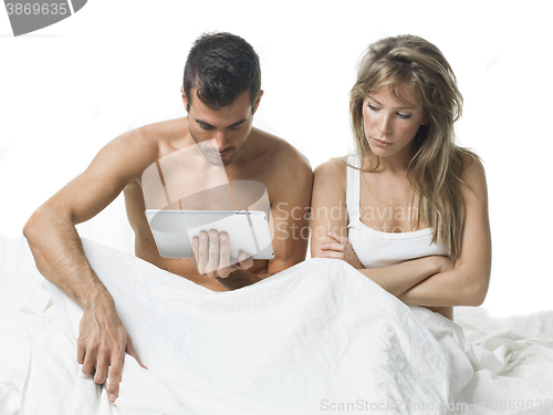 Image of uncommunicative couple on bed in white 