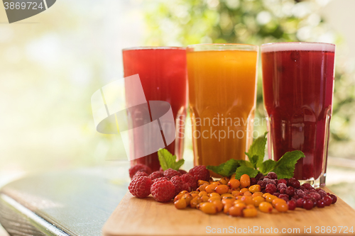 Image of fruit drink with cranberries raspberries and sea buckthorn