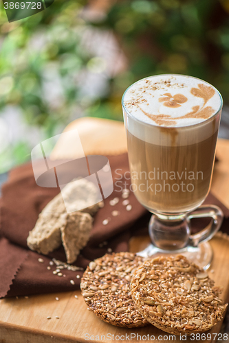 Image of coffee latte cup with cookies