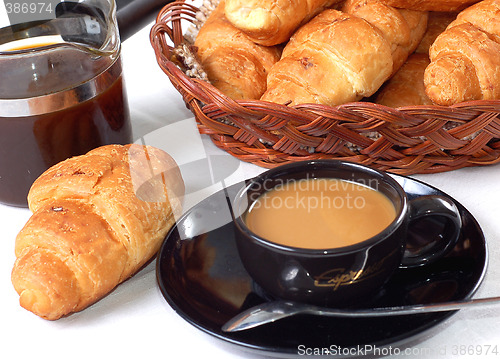 Image of cup of coffee with fresh croissants