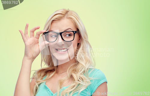 Image of happy young woman or teenage girl in glasses