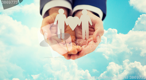 Image of close up of happy male gay couple with love symbol