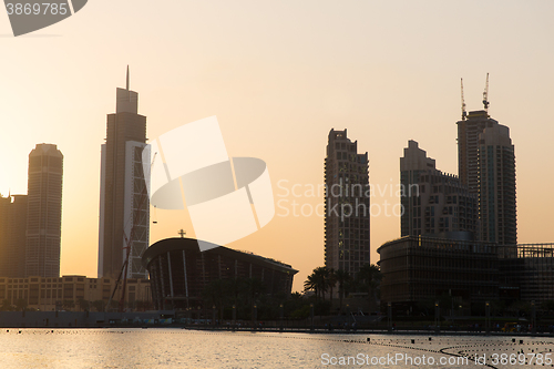 Image of Dubai city skyscrapers on seafront at evening