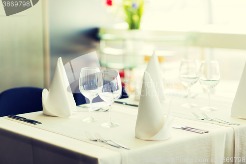 Image of close up of table setting with glasses and cutlery