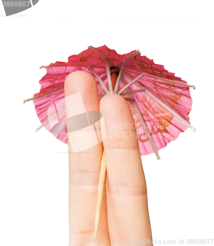 Image of close up of two fingers with cocktail umbrella