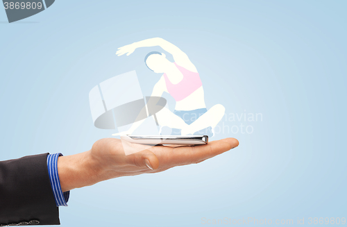 Image of male hand with smartphone and sportswoman