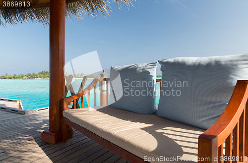 Image of patio or terrace with canopy and bench on beach