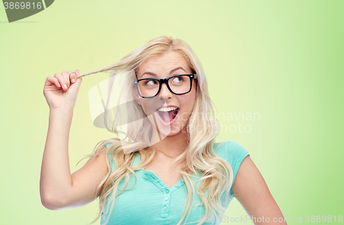 Image of happy young woman or teenage girl in glasses