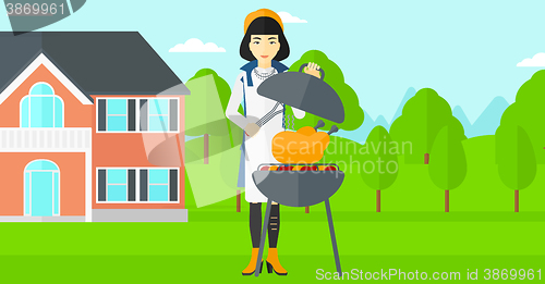 Image of Woman preparing barbecue.