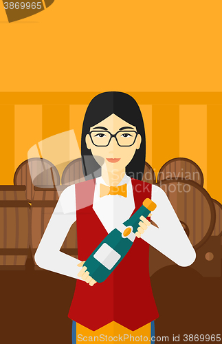 Image of Waitress holding bottle of wine.