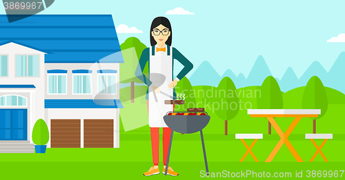 Image of Woman preparing barbecue.