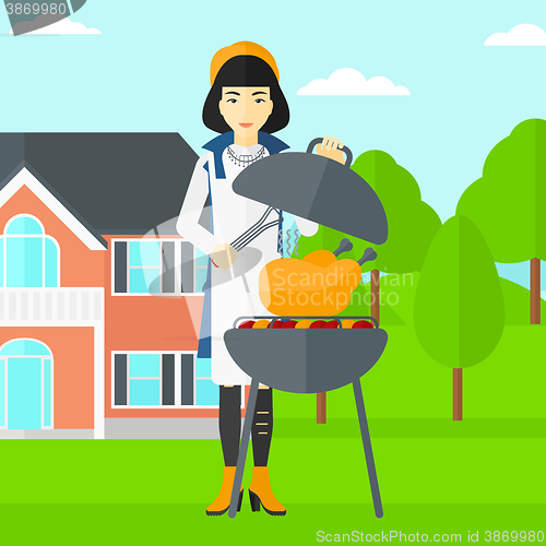 Image of Woman preparing barbecue.