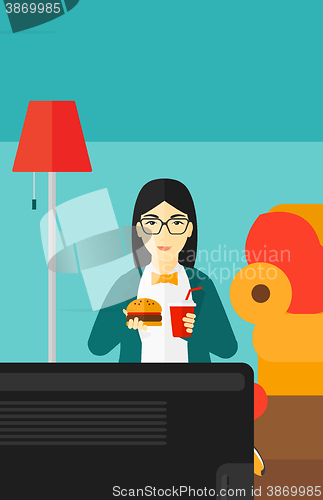 Image of Woman eating hamburger. 