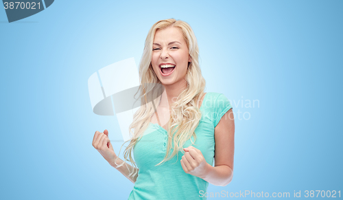 Image of happy young woman or teen girl celebrating victory