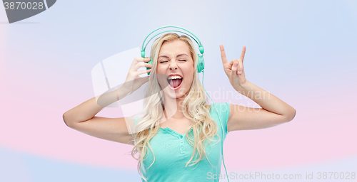 Image of happy young woman or teenage girl with headphones