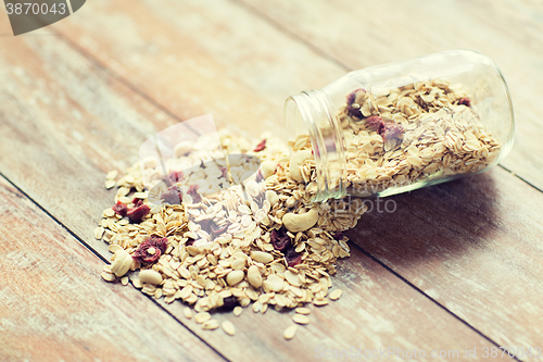 Image of close up of jar with granola or muesli on table