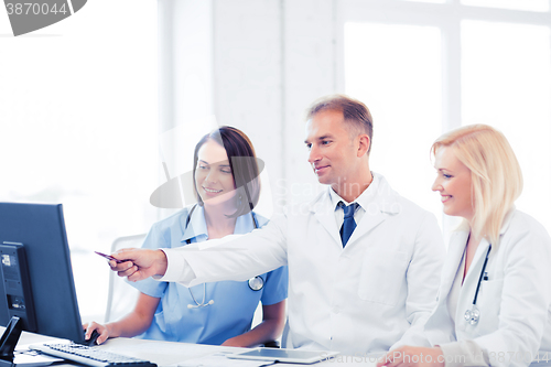 Image of doctors looking at computer on meeting