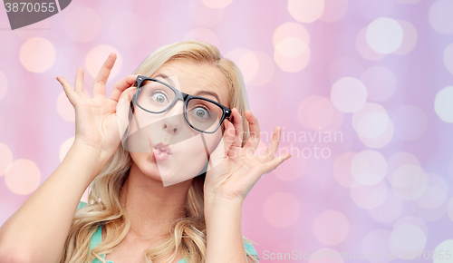 Image of happy young woman in glasses making fish face