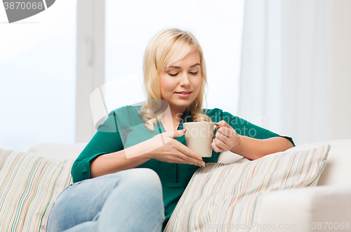 Image of happy young woman at home