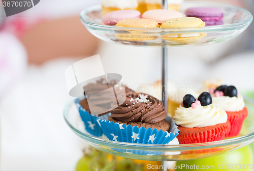 Image of close up of cake stand with cupcakes and cookies