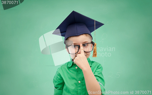 Image of happy boy in bachelor hat and eyeglasses